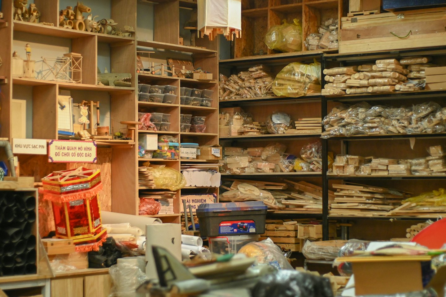 Wooden shelves filled with craft supplies and a decorative lantern.